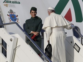 Pope Francis, unlike Josh Freed, doesn't forget his bag when boarding a plane in Italy.