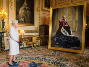 Queen Elizabeth II views a portrait of herself by British-Canadian artist Henry Ward: "I wanted a strong queen in my portrait, a queen of warmth but also of reserve." The portait was unveiled at Windsor Castle Friday.