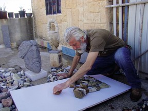 Sculptor Nizar Ali Badr uses stones he finds along the seashore in Latakia, Syria, to create images. Canadian children's author Margriet Ruurs persuaded him to illustrate Stepping Stones: A Refugee Family's Journey.