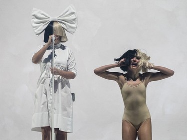 Australian musician Sia Furler, left, performs as part of her Nostalgic for the Present Tour at the Bell Centre in Montreal on Sunday, Oct. 23, 2016.