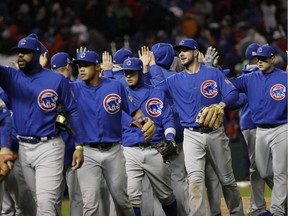 The Chicago Cubs celebrate after Game 2 of the Major League Baseball World Series against the Cleveland Indians Wednesday, Oct. 26, 2016, in Cleveland. The Cubs won 5-1 to tie the series 1-1.