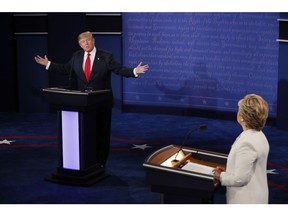 Republican nominee Donald Trump speaks as Democratic nominee Hillary Clinton looks on during the final presidential debate.