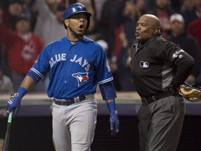 Toronto Blue Jays' Edwin Encarnacion reacts to a called third strike by home plate umpire Laz Diaz against the Cleveland Indians during the eighth inning of game one of the American League Championship Series in Cleveland on Friday, Oct. 14, 2016.