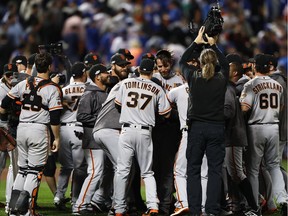 Madison Bumgarner (#40) of the San Francisco Giants celebrates with teammates after they defeated the New York Mets 3-0 to win the National League Wild Card game at Citi Field on October 5, 2016 in New York City.