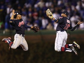 Francisco Lindor (12) and Rajai Davis (20) of the Cleveland Indians celebrate after beating the Chicago Cubs 7-2 in Game Four of the 2016 World Series at Wrigley Field on Saturday, Oct. 29, 2016 in Chicago.