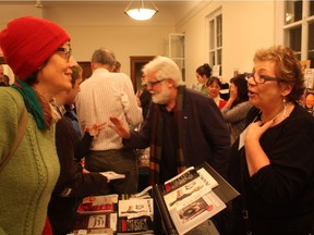 Author Kathleen Winter (left) and publisher Linda Leith at the 2015 edition of The Holiday Pop-Up Book Fair at the Atwater Library. Montreal Gazette editorial cartoonist Terry Mosher, aka Aislin, is in the background.