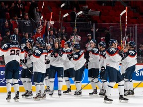 Team Slovakia raises their sticks in appreciation towards the fans after defeating Team Czech Republic in a quarterfinal round during the 2015 IIHF World Junior Hockey Championships at the Bell Centre on January 2, 2015 in Montreal, Quebec, Canada.  Team Slovakia defeated Team Czech Republic 3-0.
