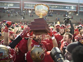 Laval Rouge et Or's Anthony Dufour, centre, celebrates with teammates after winning the Uteck Bowl against Laurier Golden Hawks for the CIS national semifinal Saturday, Nov. 19, 2016, at Laval University in Quebec City.
