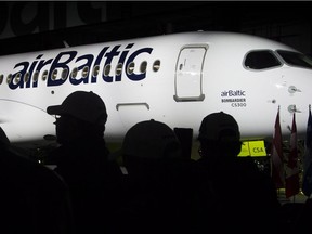 Bombardier employees attend a ceremony to mark the first delivery of Bombardier's CS300 to Air Baltic in Mirabel, Que., Monday, November 28, 2016. The largest aircraft ever made by Bombardier is about to carry passengers after being delivered to Air Baltic.
