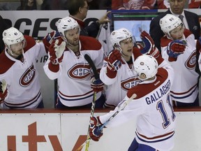 Canadiens' Brendan Gallagher (11) is congratulated by the bench after scoring during the third period of an NHL hockey game against the Detroit Red Wings on Saturday, Nov. 26, 2016, in Detroit.