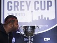 Calgary Stampeders defensive-lineman Charleston Hughes pretends to kiss the Grey Cup ahead of the 104th CFL Grey Cup against the Ottawa Redblacks in Toronto on Thursday, Nov. 24, 2016.