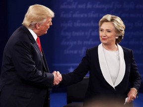 Republican presidential nominee Donald Trump shakes hands with Democratic presidential nominee former Secretary of State Hillary Clinton during the town hall debate at Washington University on Oct. 9, 2016. in St Louis. Americans will cast their votes for president on Tuesday, Nov. 8
