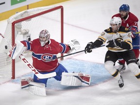 Montreal Canadiens goalie Carey Price (31) makes a save as Boston Bruins right wing David Backes (42) and Montreal Canadiens defenceman Andrei Markov (79) look for the rebound during second period NHL hockey action Tuesday, Nov.8, 2016 in Montreal.