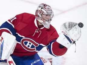 Montreal Canadiens goalie Carey Price gloves the puck during an NHL game against the Philadelphia Flyers in Oct. 2016.