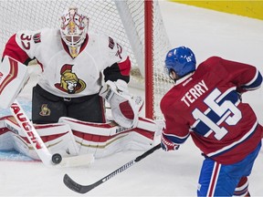 Ottawa Senators goaltender Chris Driedger makes a save against Montreal Canadiens' Chris Terry during second period NHL pre-season hockey action in Montreal, Thursday, September 29, 2016.