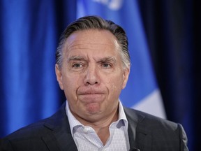 CAQ leader François Legault pauses as he speaks to the media in St-Jerome to announce the party's plan to reduce the number of immigrants to Quebec from 50,000 to 40,000 per year on Tuesday, August 30, 2016.