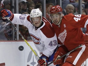 Canadiens' Daniel Carr (43) and Detroit Red Wings defenceman Ryan Sproul (48) chase the puck during the first period of an NHL hockey game, Saturday, Nov. 26, 2016, in Detroit.