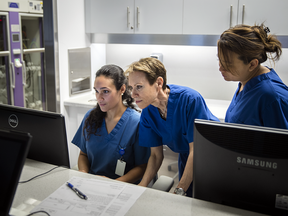 Doctor Carol-Ann Vasilevsky, centre, in her private clinic Endovision with registered nurses Gabrielle Hominh, right, and Tiffany Pontes. 
"I don't know what we're going to do with all these patients," Vasilevsky says. "The public system has been stretched to a thread."