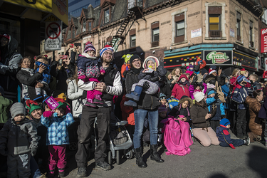 Children and adults watch the annual Santa Claus Parade on Ste-Catherine street in downtown Montreal on Saturday, November 19, 2016.