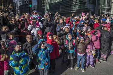 Children and adults watch the annual Santa Claus Parade on Ste-Catherine street in downtown Montreal on Saturday, November 19, 2016.
