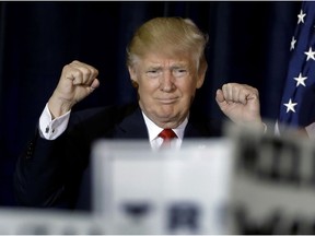Republican presidential candidate Donald Trump pumps his fists as he takes the stage during a campaign rally Saturday, Nov. 5, 2016, in Tampa, Fla.