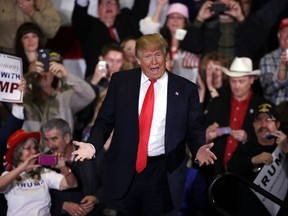 Donald Trump reacts as he walks up to the stage during a campaign rally Tuesday, Feb. 23, 2016, in Reno, Nev.