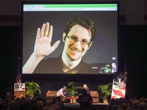 Edward Snowden appears on a live video feed broadcast from Moscow at an event sponsored by ACLU Hawaii in Honolulu on Feb. 14, 2015.