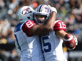 Alouettes wide receiver Samuel Giguère (15) gets a hug from slotback Nik Lewis (8) after his touchdown  against the Tiger-Cats in Hamilton, Ont., on Saturday, Nov. 5, 2016.