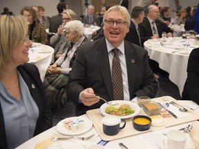 Quebec Health Minister Gaetan Barrette, right, and Quebec Minister responsible for Seniors and Anti-Bullying Francine Charbonneau, left, sample food served in long term care facilities for seniors and hospitals, Wednesday, November 23, 2016 in Quebec City.