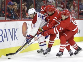 Montreal Canadiens' Phillip Danault (24) chases the puck with Carolina Hurricanes' Viktor Stalberg (25), of Sweden, and Jeff Skinner (53) during the second period of an NHL hockey game in Raleigh, N.C., Friday, Nov. 18, 2016.