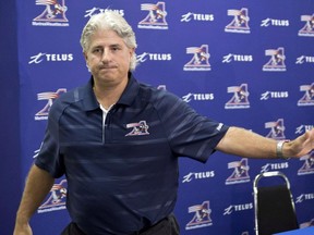 Montreal Alouettes general manager Jim Popp leaves a news conference in Montreal on Thursday, August 1, 2013. Popp will not return as general manager of the Montreal Alouettes. Team president Mark Weighman said the split was done by mutual agreement and that search for a replacement has begun.THE CANADIAN PRESS/Paul Chiasson ORG XMIT: CPT104