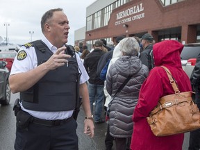 A sheriff addresses the crowd as jury selection for the trial of Jean-Claude Savoie begins in Campbelltown, N.B., Oct. 31, 2016. Savoie is charged with criminal negligence causing death after two young brothers were asphyxiated by an African rock python in August 2013.