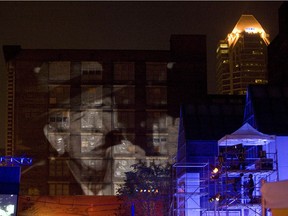 Leonard Cohen sings Hallelujah as projected on a nearby building during an homage to Leonard Cohen at the Festival International de Jazz de Montreal on Thursday, June 26, 2008.