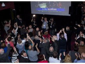 Quebec Liberal supporters react as they announce a Quebec Liberal majority government on television during the party celebrations, Monday, April 7, 2014 in St-Felicien Que.