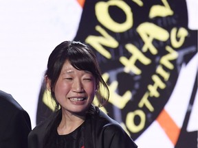 Montreal author Madeleine Thien, right, onstage after winning the 2016 Giller Prize for her book "Do Not Say We Have Nothing" in Toronto, Monday, Nov. 7, 2016.