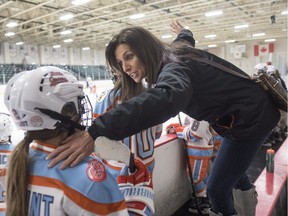 Former goaltender Manon Rhéaume gives instructions to a player while behind the bench coaching the Little Caesars Wednesday, November 2, 2016 in Detroit.