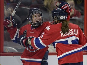 Les Canadiennes de Montreal Marie-Philip Poulin (29) celebrates with teammate Lauriane Rougeau (5), right, during first period of Canadian Women's Hockey League final action at the Clarkson Cup, Sunday March 13, 2016, in Ottawa.