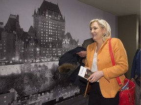 Marine Le Pen, leader of France's Front National, leaves a news conference, Sunday, March 20, 2016 in Quebec City. Well known for her anti-immigrant, nationalist and nativist positions, she was openly shunned by all main party leaders in the province.