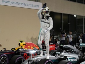 Mercedes driver Lewis Hamilton of Britain celebrates after qualifying for pole position during the qualifying session at the Yas Marina racetrack in Abu Dhabi, United Arab Emirates, Saturday, Nov. 26, 2016. The Emirates Formula One Grand Prix will take place on Sunday.