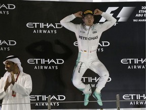 Mercedes driver Nico Rosberg of Germany celebrates on the podium after winning the 2016 world championship during the Emirates Formula One Grand Prix at the Yas Marina racetrack in Abu Dhabi, United Arab Emirates, Sunday, Nov. 27, 2016.