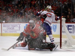 Andrew Shaw of the Montreal Canadiens is shoved in the goal by Ryan Hartman of the Chicago Blackhawks behind Corey Crawford at the United Center on Nove. 13, 2016, in Chicago.