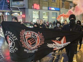 Demonstrators march on Beaubien street towards Theatre Plaza as they protest against a concert by Polish black metal rock band Graveland in Montreal on Saturday, November 26, 2016. Protesters labelling themselves "anti-fascists militants" were protesting what they call a racist band.