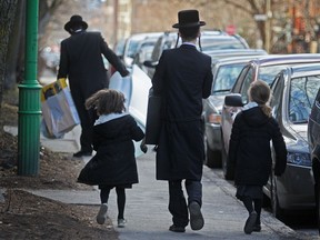 Hasidic Jews walk down Hutchison St. in Montreal, Thursday April 5, 2012.