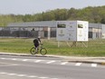 A cyclist rides past an unfinished arena in Pincourt, Thursday, May 15, 2014.  (Phil Carpenter / THE GAZETTE)