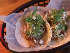 The chicken tacos are filled with juicy shredded chicken, coleslaw, salsa verde and queso fresco cheese.