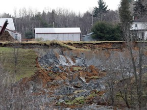 An area estimated to be the size of a football field collapsed and slid down a small hill, forcing some people out of their homes in Saint-Luc-de-Vincennes, east of Montreal, on Thursday, Nov. 10, 2016.
