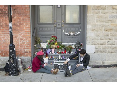 Natasha Nuhanovic, left, and Daniel Aragao Cavalcanti, fans of Leonard Cohen keep vigil at a makeshift memorial outside the late singer/songwriter's house on Vallières in Montreal, Friday November 11, 2016.  Cohen died in 82 overnight on Thursday the 10th.