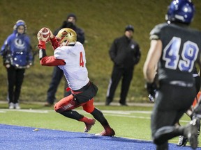 Laval Rouge et Or quarterback Hugo Richard crosses the goal line for the game- winning touchdown during the last minute of the Quebec university football championship game against the Carabins de Université de Montréal in Montreal on Saturday, Nov. 12, 2016.