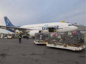 Baggage handlers load aid supplies, bound for Haiti on an Air Transat plane at Pierre Elliott Trudeau International Airport in Dorval, Monday November 15, 2016.  (Phil Carpenter / MONTREAL GAZETTE)