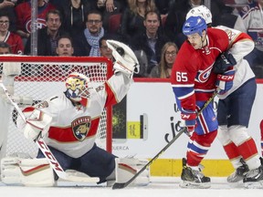Panthers goalie Roberto Luongo makes a glove save as Canadiens Andrew Shaw hovers near the end while being tied up by Panthers defenceman Jason Demers during second period Tuesday night at the Bell Centre.